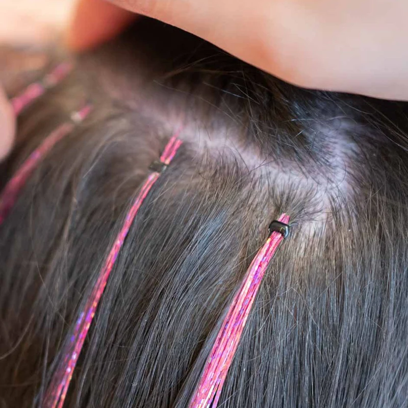 Pink hair tinsel secured with tiny silicone micro beads